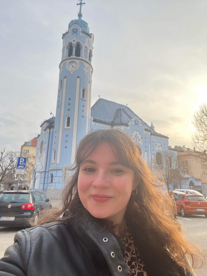 Woman in front of the Blue Church in Bratislava.