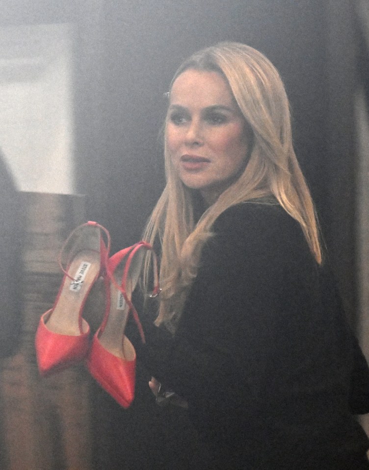 Amanda Holden carrying a pair of red shoes.