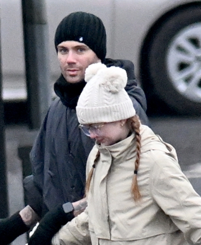 Max George and Maisie Smith walking a dog.