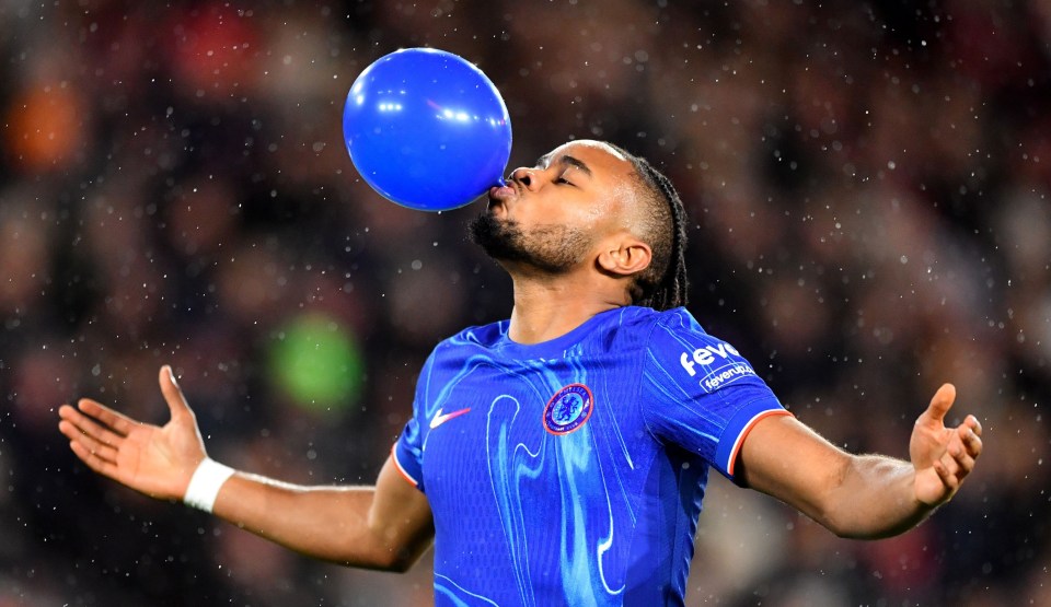 Christopher Nkunku of Chelsea inflating a blue balloon.