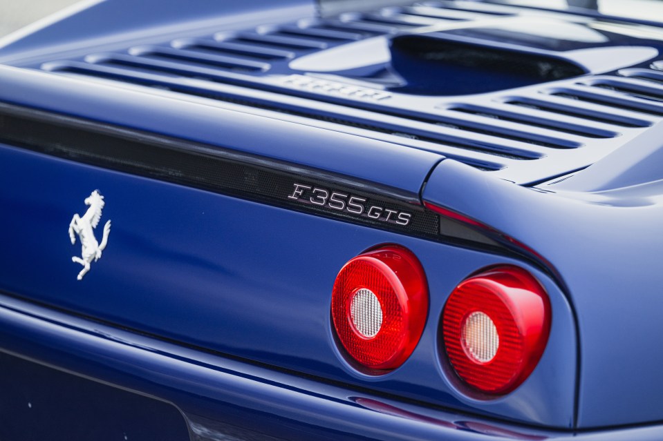 Rear view of a blue Ferrari F355 GTS.