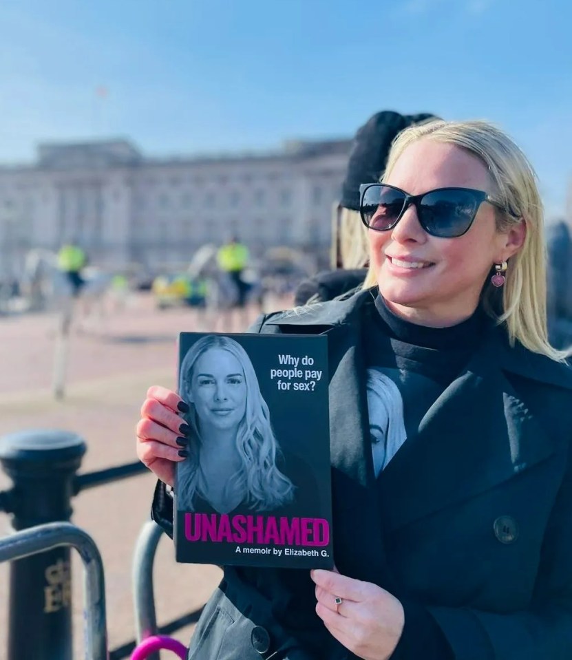 Woman holding a copy of "Unashamed," a memoir by Elizabeth G., in front of Buckingham Palace.