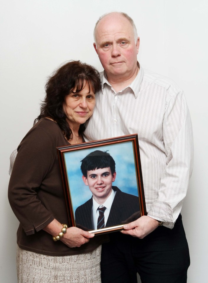 Barry and Margaret Mizen holding a framed photo of their son, Jimmy.