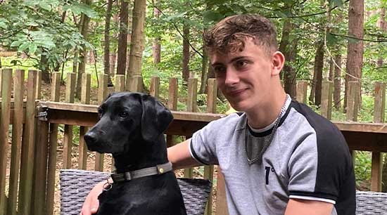 Tribute photo of Cory Chilvers, 18, with his dog.