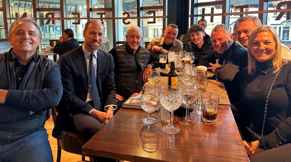 The Prince of Wales with Aston Villa supporters in a pub.