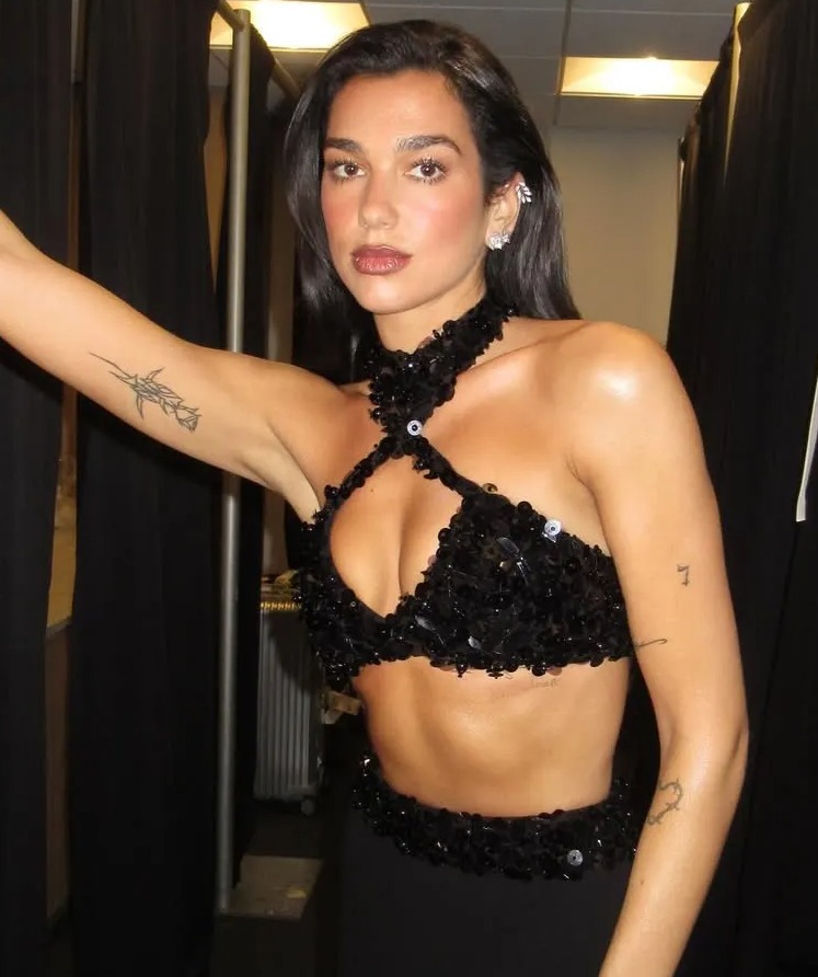 Dua Lipa in a black sequined two-piece outfit.