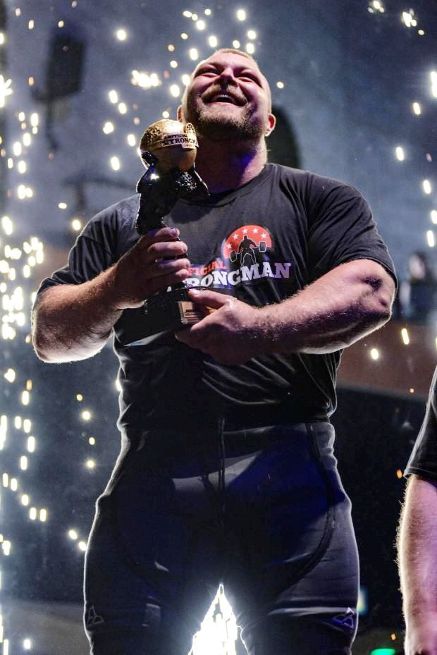 England's Strongest Man, Kane Francis, holding his trophy.