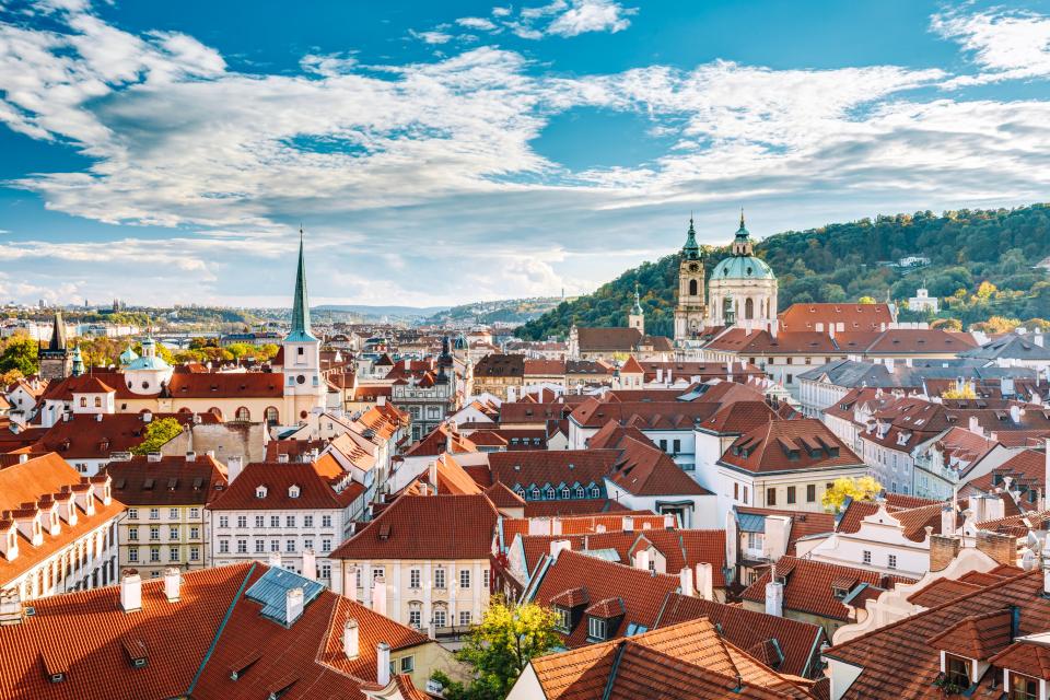 Aerial view of Old Prague, Czech Republic, showing red rooftops and churches.