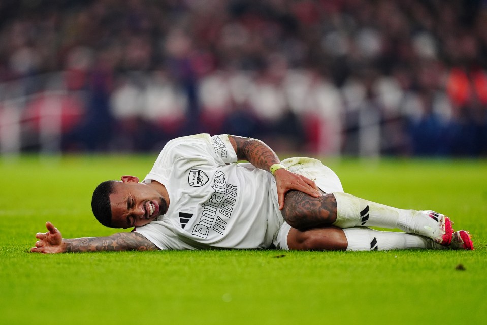 Arsenal's Gabriel Jesus on the ground clutching his injured knee.