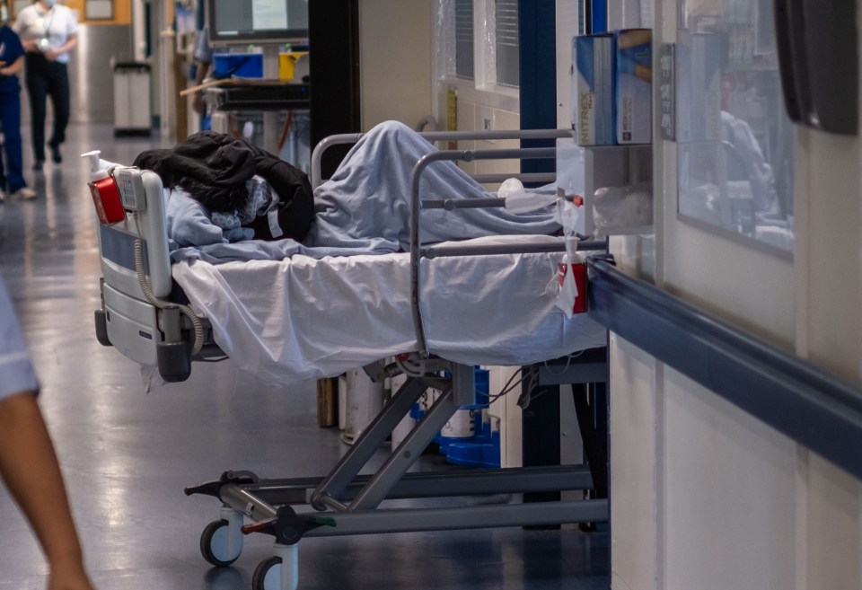 Patient bed in NHS hospital ward.