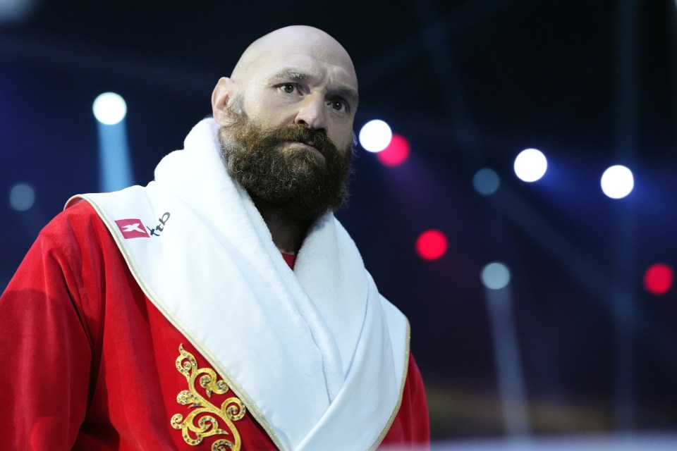 Tyson Fury in a red robe and white towel.