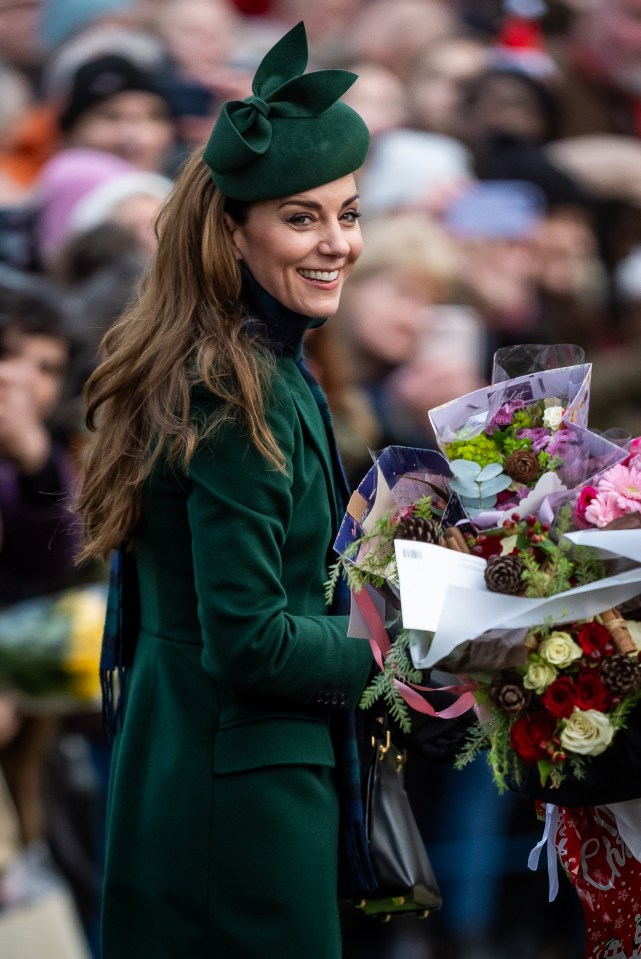 The Princess of Wales smiling and holding flowers after a Christmas church service.