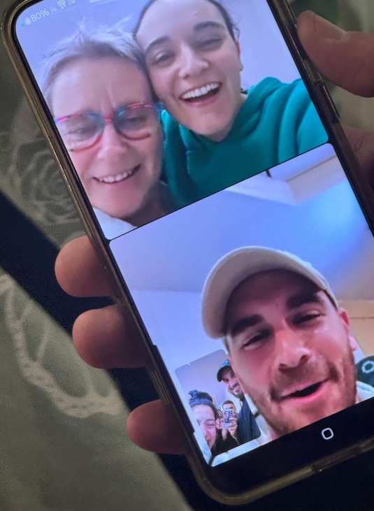 Photo of a phone screen showing a video call with a released British-Israeli hostage and others.