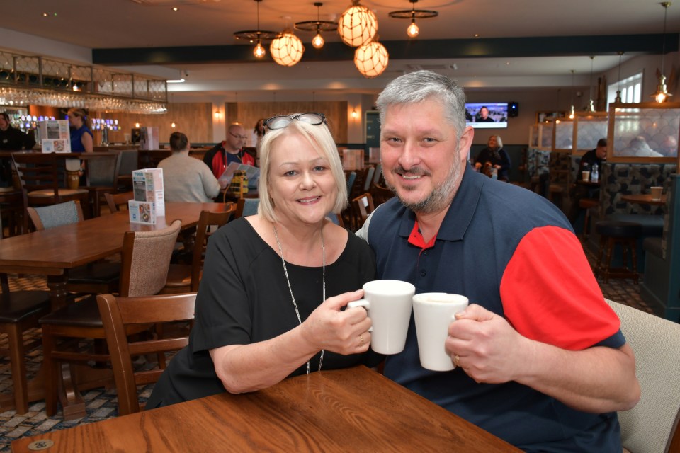 Couple enjoying coffee in a new pub.