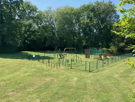 Playground surrounded by trees.