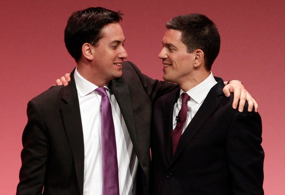 David Miliband and Ed Miliband embracing at a Labour party conference.