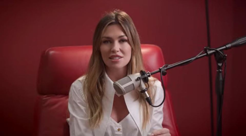 Woman speaking into a microphone.