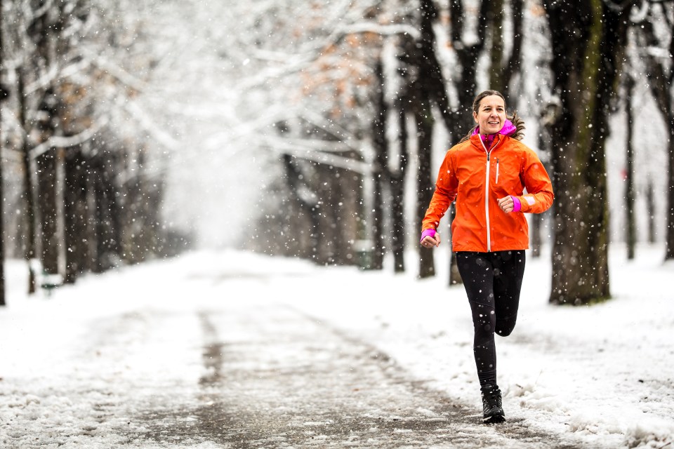 Woman jogging in the snow.