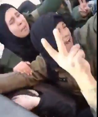 Women crying in a crowded vehicle.