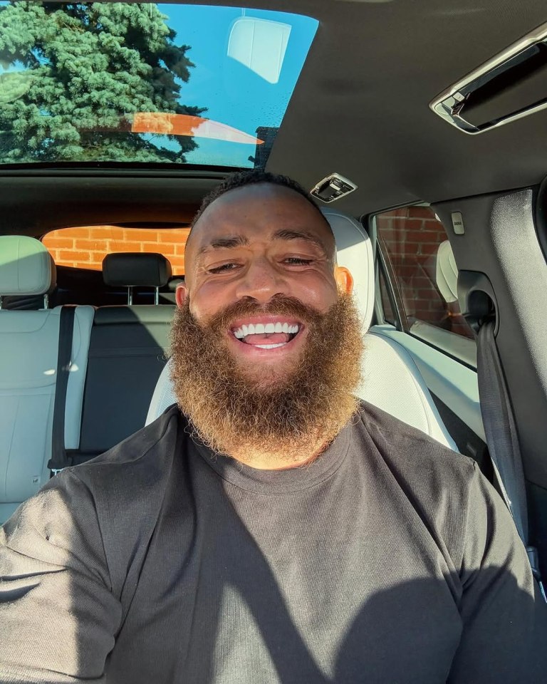 Ashley Cain smiling in a car.