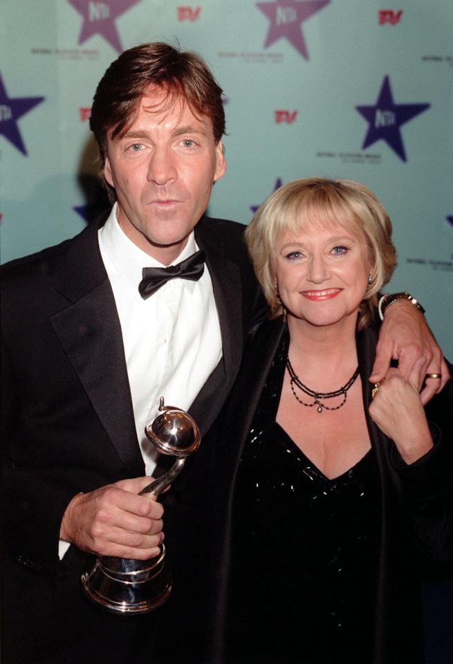 Richard Madeley and Judy Finnigan holding a National Television Award.