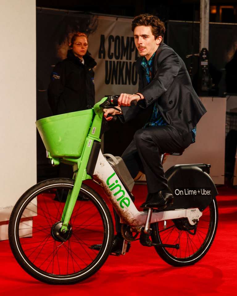 Will Gamble on a Lime electric bike at a film premiere.