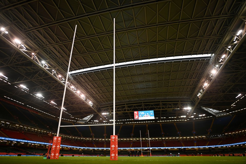 Rugby posts on a stadium field.