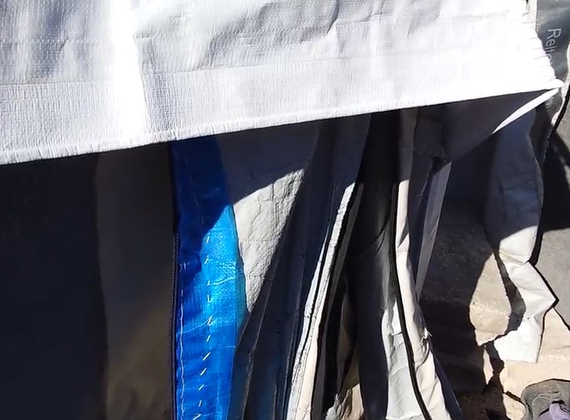 Close-up of a tent's zipper and seams.