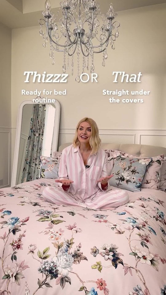 Holly Willoughby sitting on a bed in pink pajamas, showing Dunelm bedding.