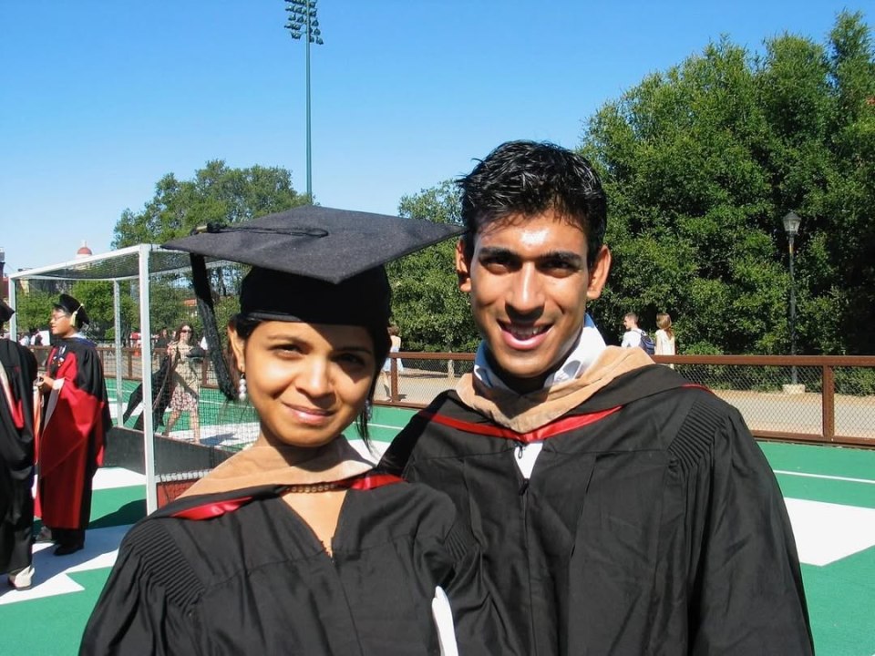 Two graduates in academic regalia.