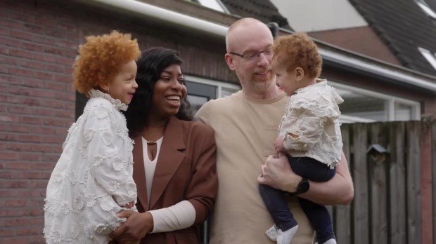 Family portrait of a mixed-race couple with their two young children.