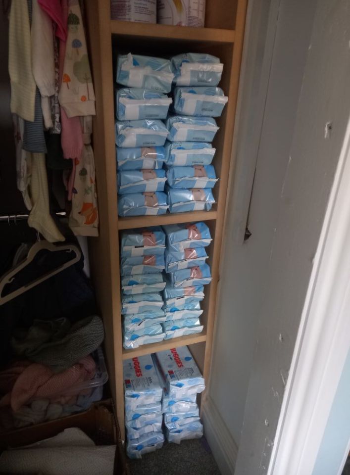 A shelf filled with multiple packs of baby wipes.