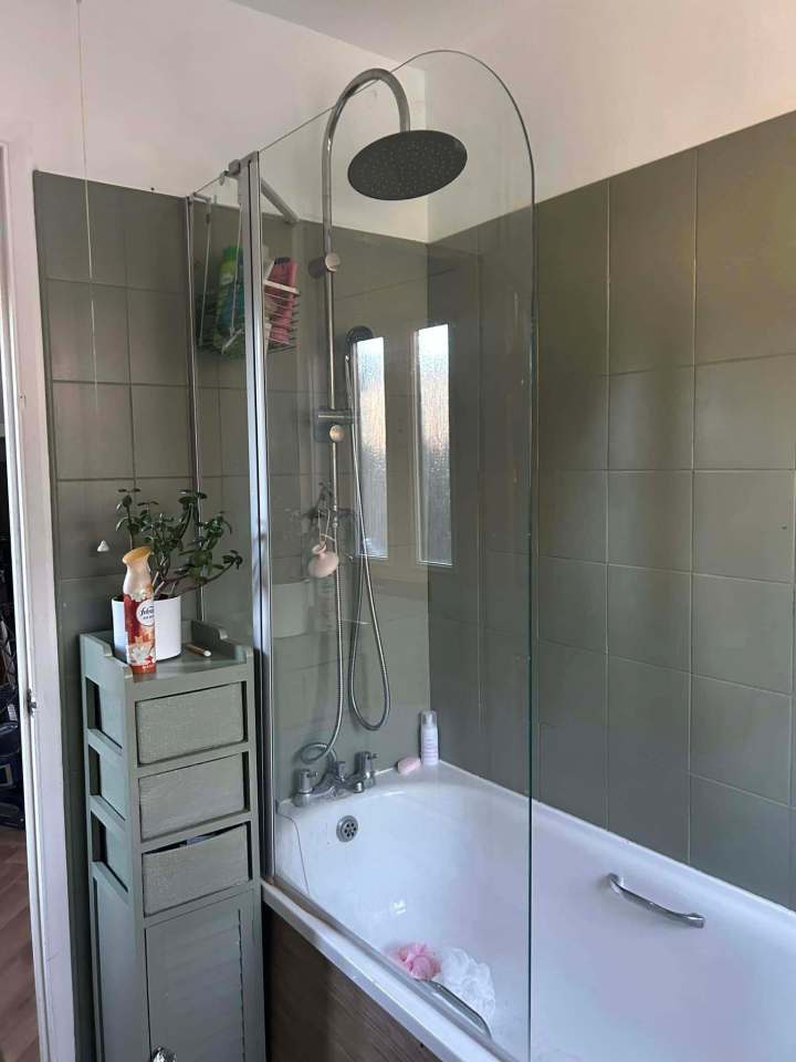 Bathroom makeover with a new shower screen and olive green tiles.