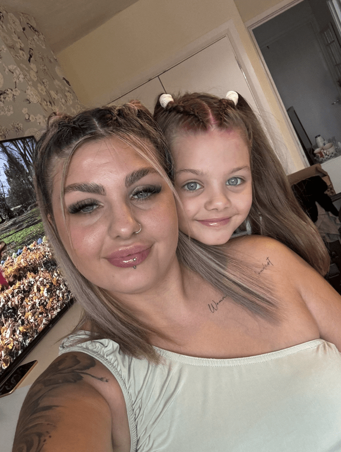 Woman and young girl posing for a selfie.