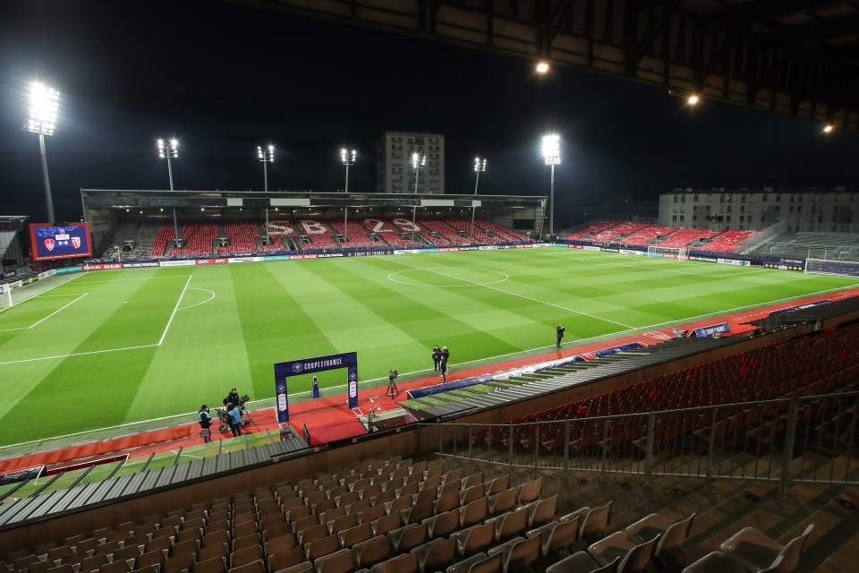 Illustration of an empty soccer stadium at night.