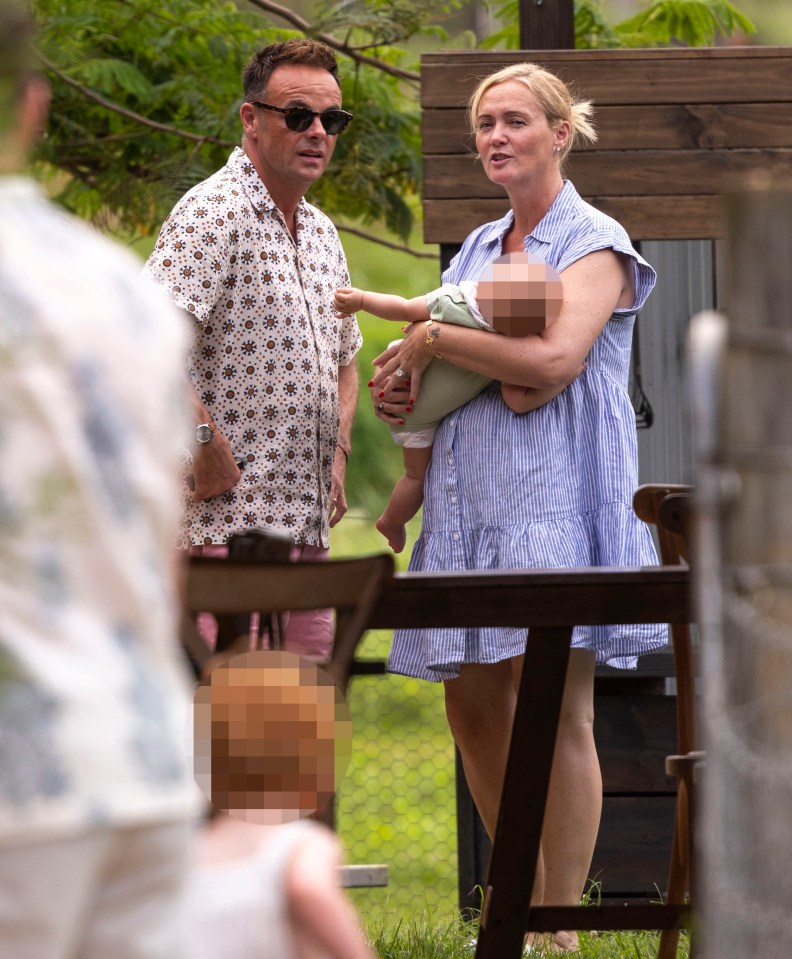 Ant McPartlin and Anne-Marie Corbett with their baby son at an outdoor restaurant.