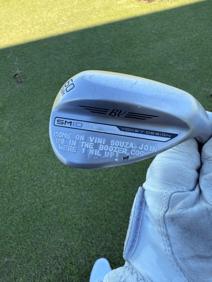 Golf wedge with personalized message.