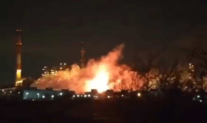 Large fire at an industrial plant at night.