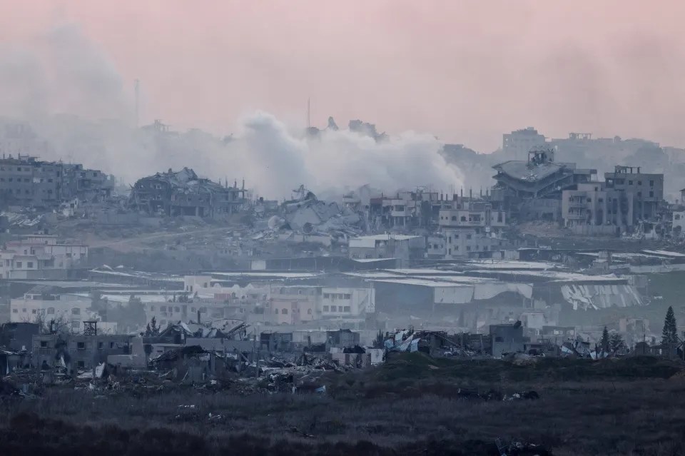 War-torn buildings and smoke.