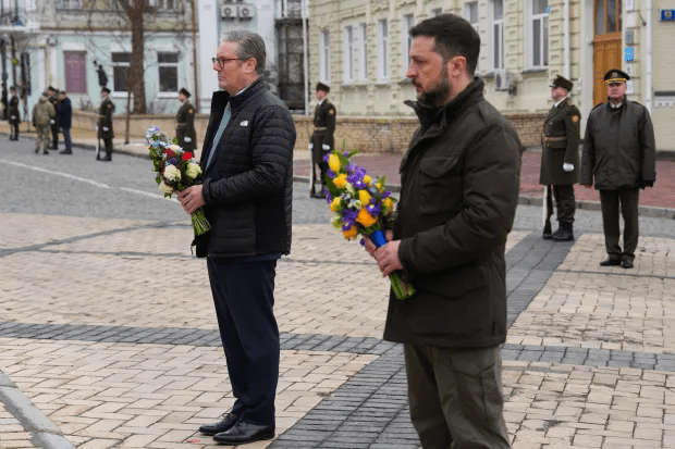 Two men holding bouquets of flowers.