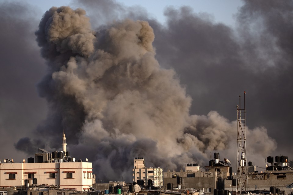 Large plume of smoke over buildings.