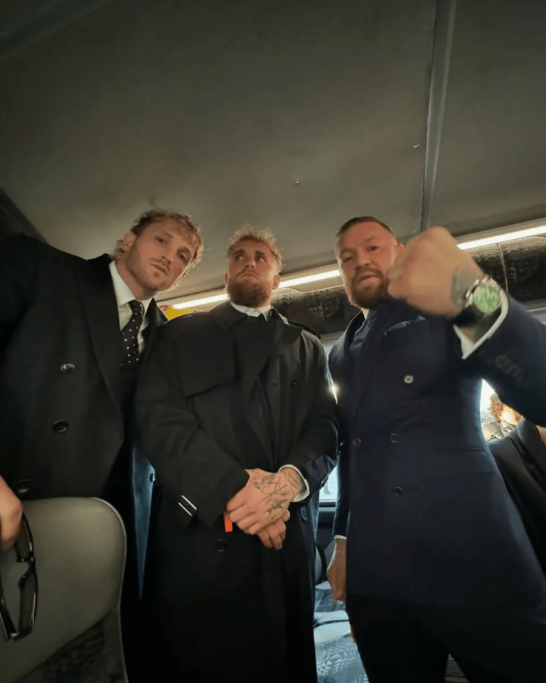 Three men in suits on a bus.