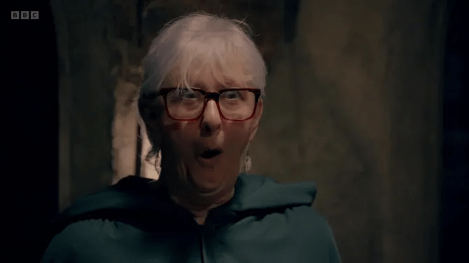 A surprised woman wearing glasses.