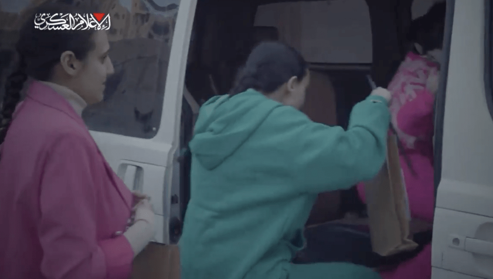 Two women loading bags into a van.