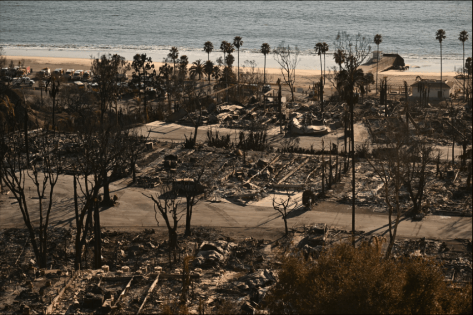 Burned-out homes near the ocean.