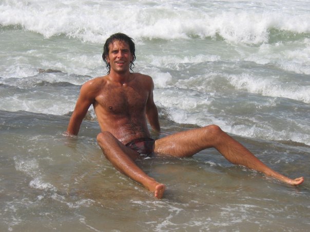 Man sitting in shallow ocean water.