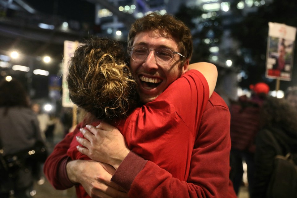 A man and woman embracing joyfully.