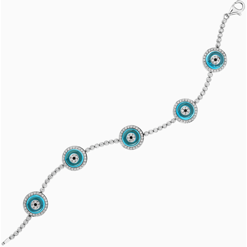 Diamond bracelet with five turquoise evil eye charms.