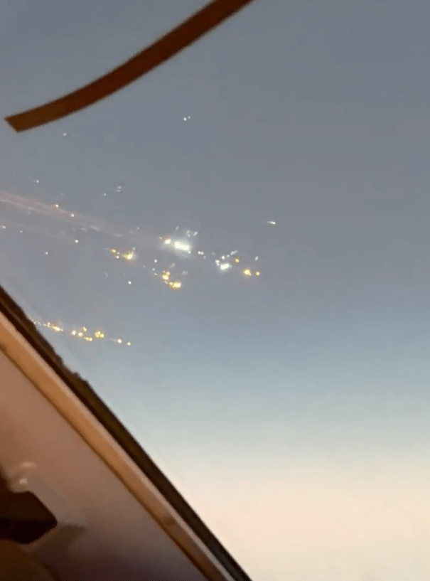 City lights viewed from an airplane window.