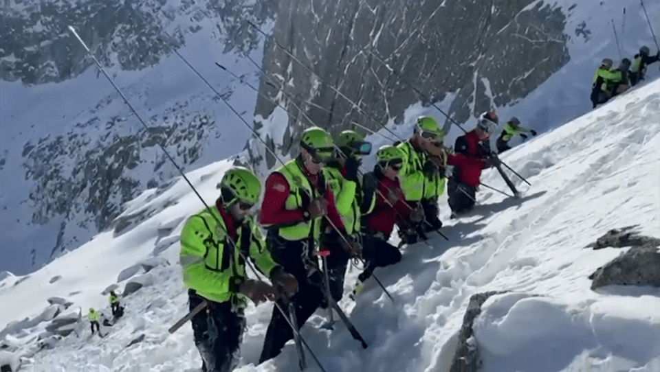 Mountain rescue team on a snowy slope.